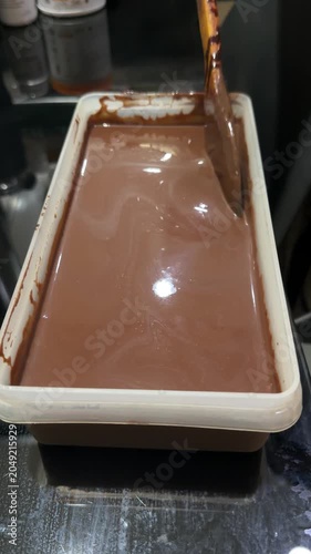 chocolate cake batter is poured into the cake pan