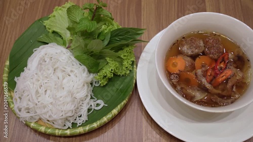 Bun Cha is a classic Vietnamese dish featuring grilled pork served in a savory-sweet dipping broth with pickled vegetables and rice vermicelli.