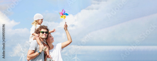 Happy family with child and colorful pinwheel near wind turbines (17) in industrial and commercial environment