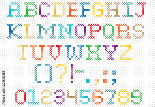 Fotografía Cross stitch style alphabet letters in yellow, red, green, blue, and white on a