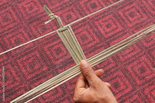 The process of making suket puppets, which are made from a type of grass called mendong