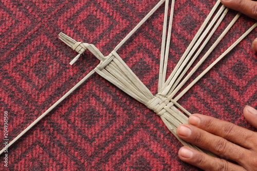 The process of making suket puppets, which are made from a type of grass called mendong