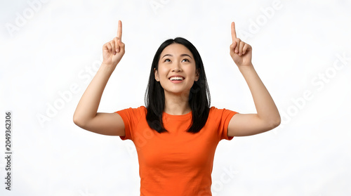 Young Asian woman smiling and pointing upwards with both index fingers, indicating a direction or highlighting something above PNG Isolated on transparent background