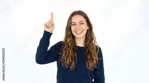 Young woman with long curly hair smiling and pointing her index finger upwards indicating an idea or a solution PNG Isolated on transparent background