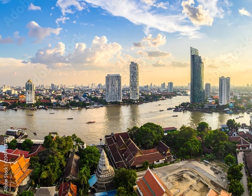 Aerial view of a sprawling metropolis bisected by a river, with modern and historic architecture