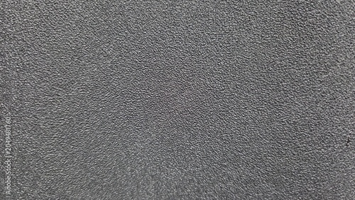Detailed macro of fine black textured surface with subtle grain pattern, perfect for abstract backgrounds, industrial design, and modern wallpaper concepts