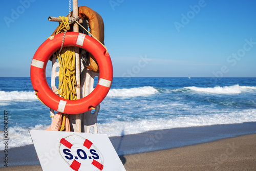 Картината върху платно Lifebuoy ring on beach safety station by sea