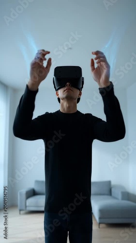 Man wearing virtual reality headset gesturing in modern living room.