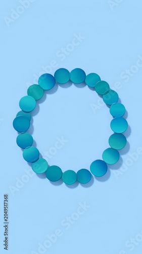 Blue spheres forming a circle on a light blue background stop motion animation.