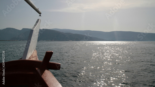 Canvastavla View from the bow of a traditional dhow crossing a sunlit fjord, Musandam, Oman
