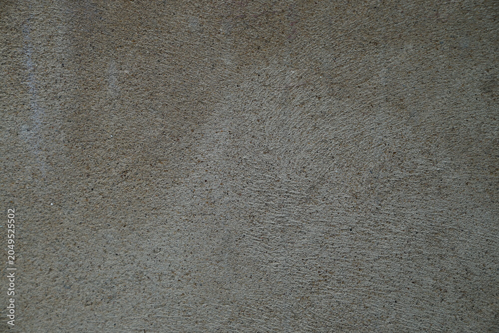 Fototapeta premium A rough grey concrete wall texture with a weathered stone pattern provides a grunge backdrop for construction design