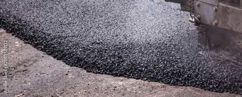 Schilderij op canvas City Street Revitalization Through Asphalt Paving Process Under Bright Sunlight