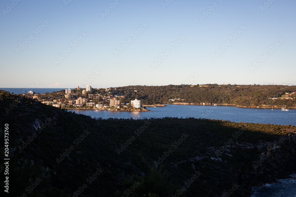 Obraz premium Coastal Cityscape View Under Clear Blue Sky