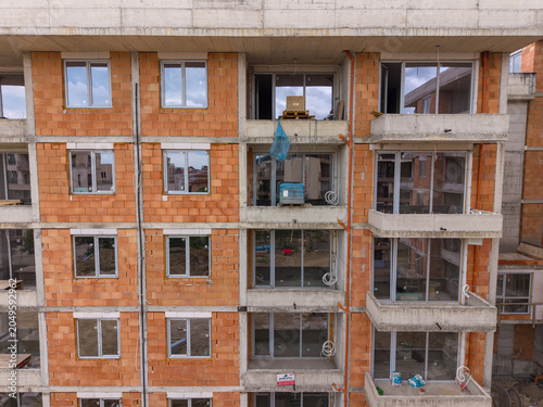 Fotografie New building construction underway with open windows and bare walls