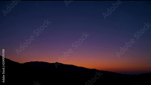 The series of images captures the transition from sunset to night over a mountainous landscape