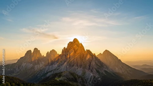 The video captures a sequence of scenes showcasing a mountain range during sunset
