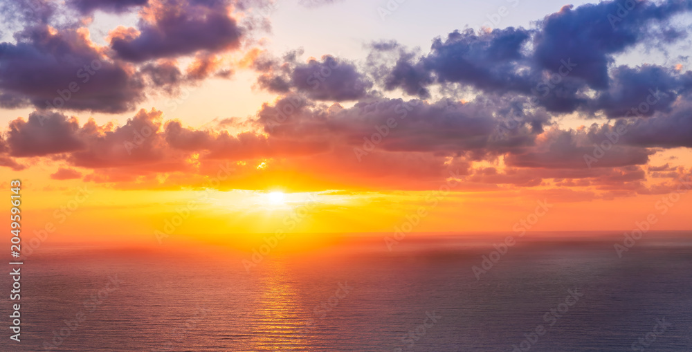 Fototapeta premium beautiful sunrise or sunset seascape with amazing calm sea water with waves and colorful amazing cloudy morning sky on background