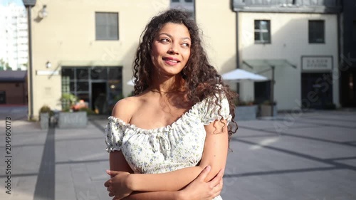 Portrait of young pretty trendy girl posing at the city, summer street fashion.