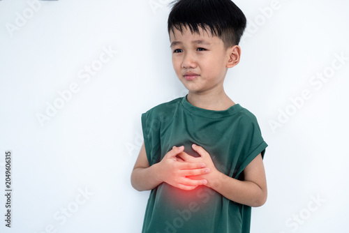 Quadro su tela Anxious Asian boy clutching his chest in pain, experiencing sudden,  stomachache, heartburn or acid reflux symptoms