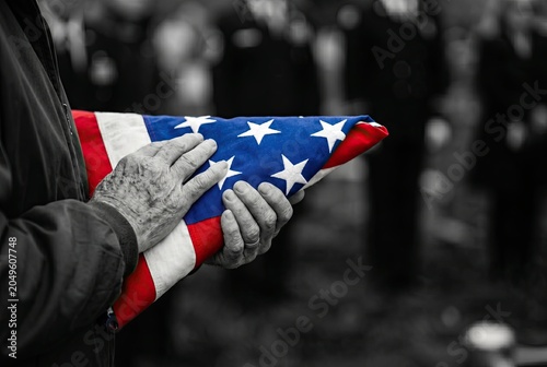 Generated AI set photos elderly hands holding folded American flag military funeral service
