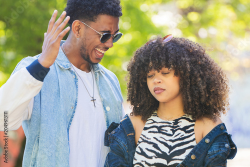 Fotografie young couple on the street arguing angrily