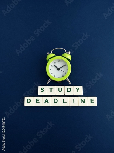 Study deadline approaching with alarm clock ticking