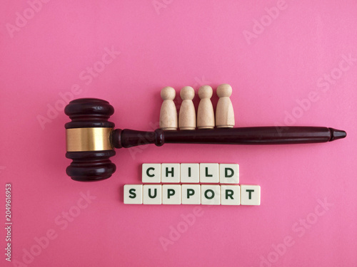 Gavel with wooden figures representing child support concept
