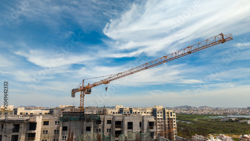 Konstfotografi Tower Crane Above High Rise Residential Construction Against Dramatic Sky