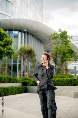 Businesswoman talks on phon...