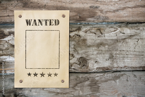 wanted poster on old wooden background