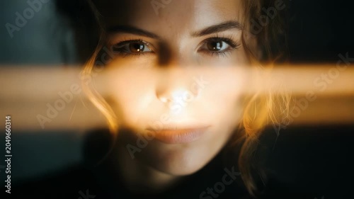 Woman's Face Illuminated by Bright Light Beam, Moody Cinematic Portrait
