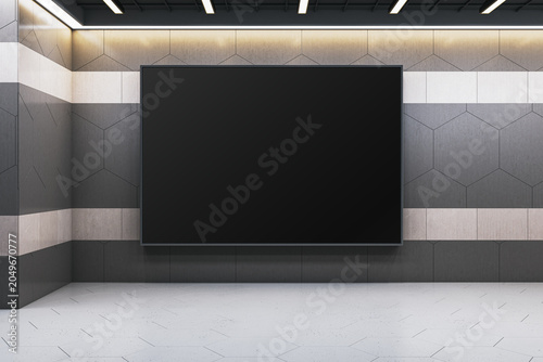 Large blank black display screen on modern geometric wall in contemporary int...