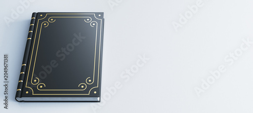 Fotografía Classic hardcover book with ornate gold design lying on light background offering clean space for creative branding mockup purposes