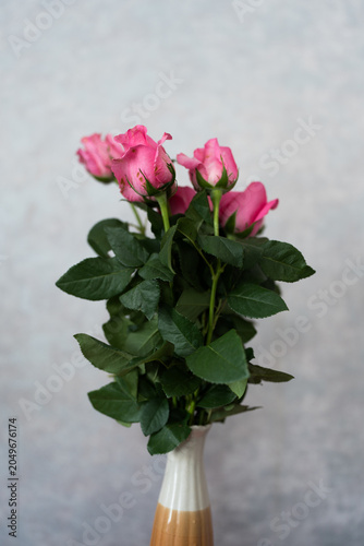 A beautiful bouquet of pink roses on a gray surface