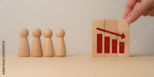 AI Workforce Displacement and Employment Transformation. Wooden figures face a declining workforce chart. AI-driven automation, job displacement, labor shifts, and economic transformation.