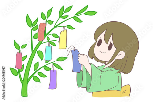 Εκτύπωση καμβά Cute girl in yukata hanging a tanzaku on a Tanabata bamboo tree