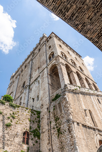 Low angle view from Via Baldassini of Palazzo dei Consoli, medieval landmark in historic center, Gubbio, Umbria, Italy 