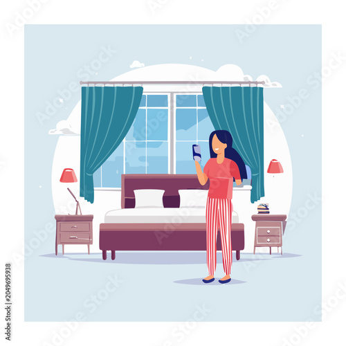 Woman holding smartphone in bedroom
