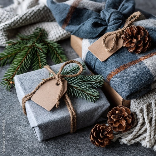 Winter Holiday Presents with Natural Decorations on a Grey Textured Background