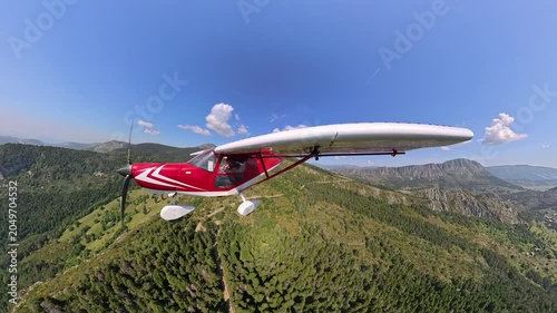 aerial footage, selfportrait of light airplane flying over provencal landscape under blue sky and beautiful wthite clouds