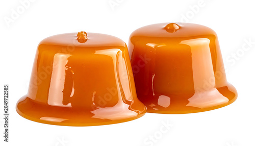 Two shiny caramel candies with a smooth glossy surface and a small peak on top, isolated on a white background, delicious sweet treats