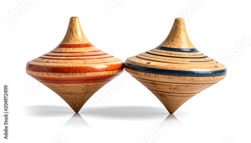 Two vintage wooden spinning tops with red and blue stripes, isolated on white background, vintage toy, classic game