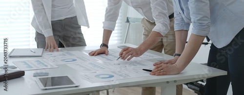 Foto Business professionals collaborating around a modern office table, reviewing cha