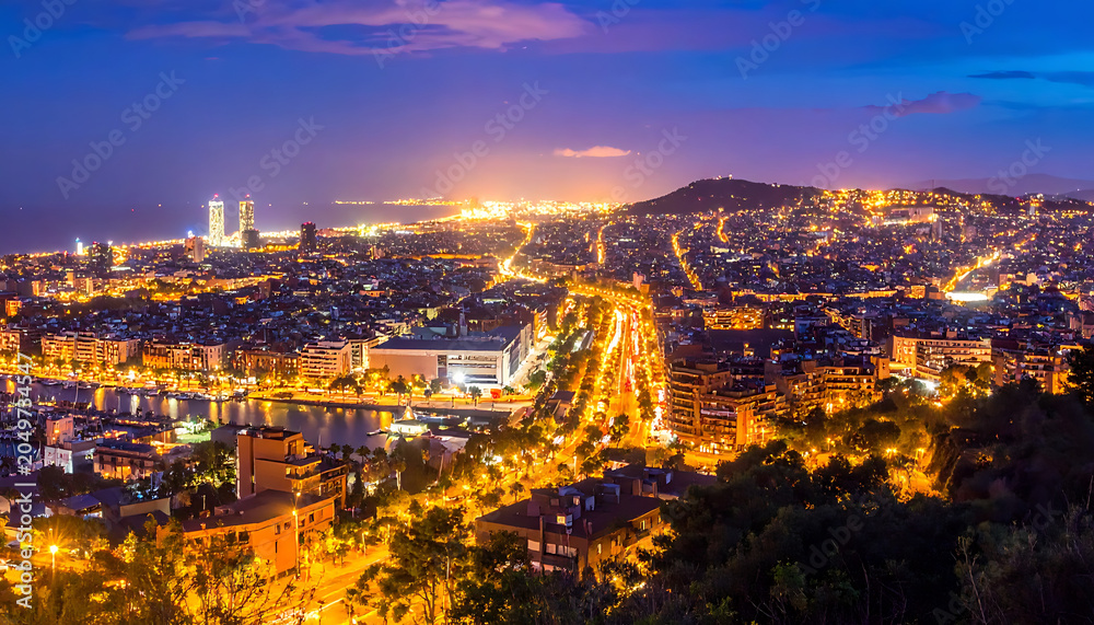Obraz premium Vibrant city skyline at dusk, illuminated by countless lights, coastal city, urban sprawl, aerial view