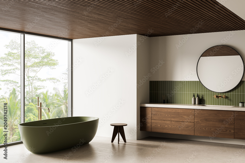 Obraz premium Minimalist bathroom interior with green freestanding tub, wood cabinetry and large window overlooking lush trees in serene style. 3D Rendering