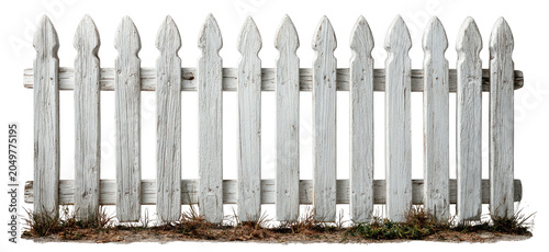 Weathered white picket fence with pointed tops, sparse grass below