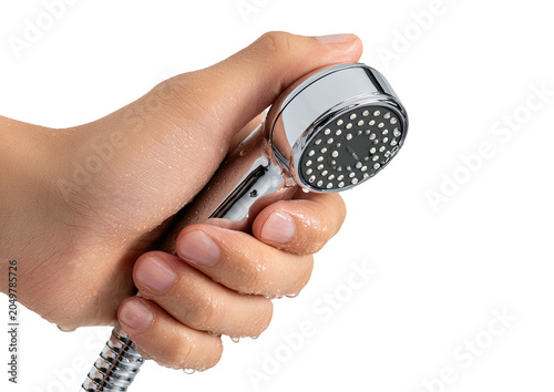 Chrome showerhead held by a hand. Black background