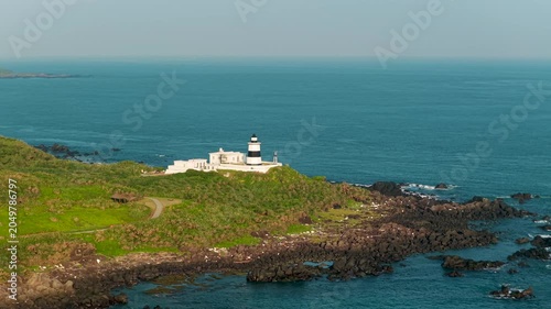 Aerial view of coastal lighthouse on rocky shore in Taiwan 