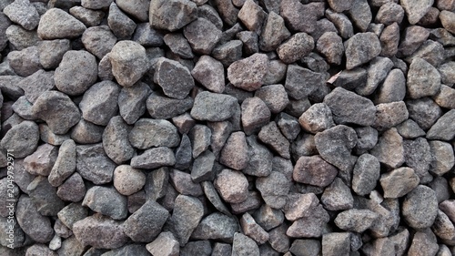 Foto ​Close-up of crushed grey stones texture, abstract gravel background