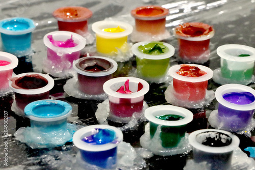 Colored inks in caps or containers ready for tattooing or painting